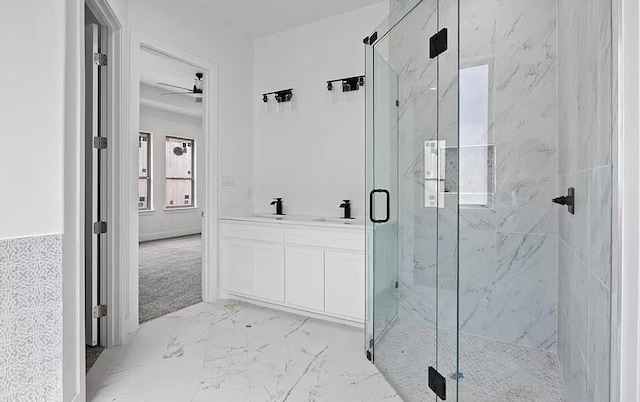 bathroom with ceiling fan, vanity, and walk in shower