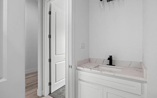 bathroom with hardwood / wood-style flooring and vanity