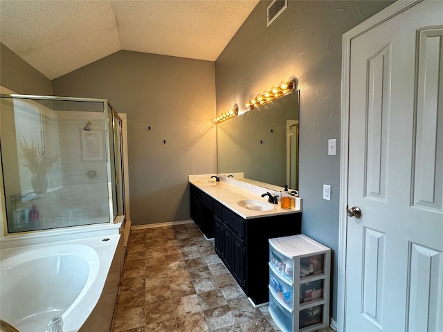 bathroom with vanity, a textured ceiling, separate shower and tub, and vaulted ceiling