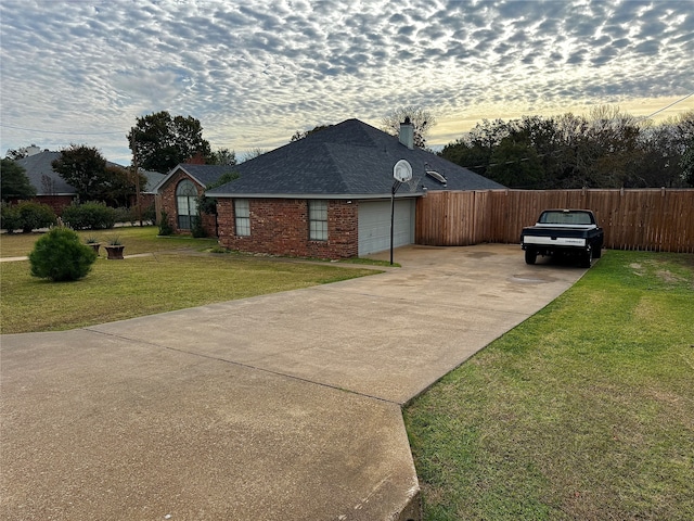 view of front of house featuring a garage and a lawn