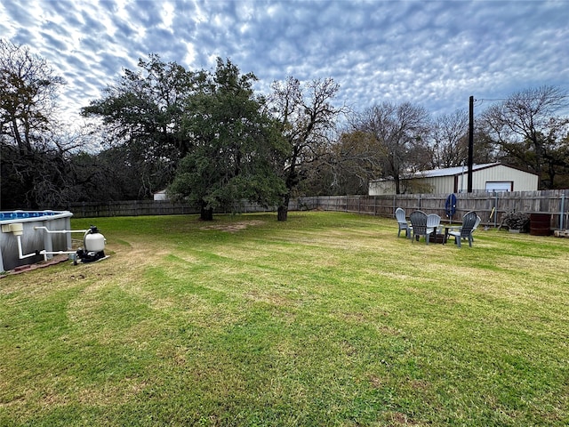 view of yard with a fenced in pool