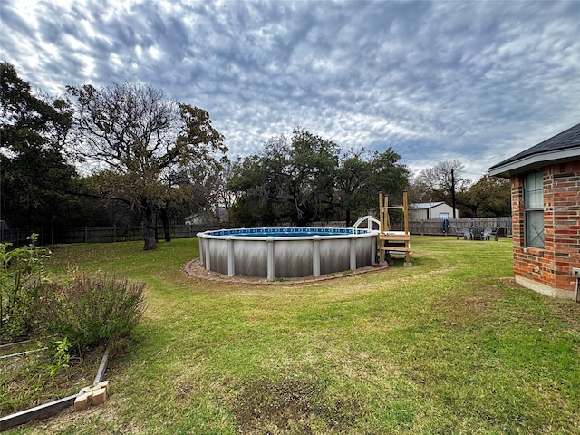 view of yard featuring a fenced in pool