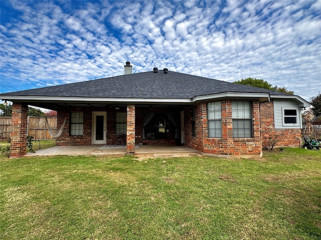 back of house featuring a yard and a patio