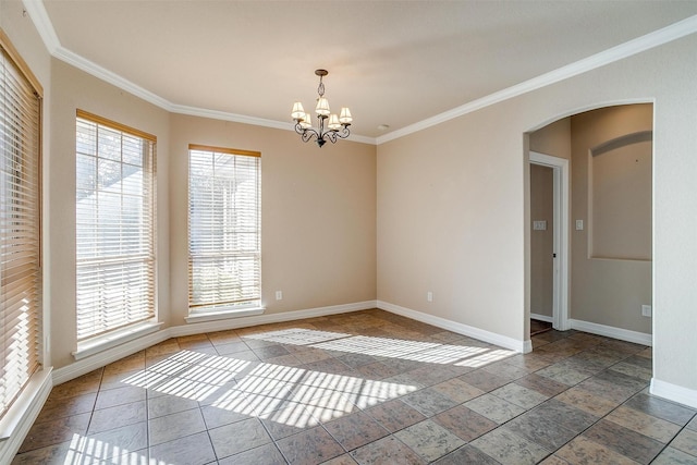 spare room featuring a notable chandelier and crown molding