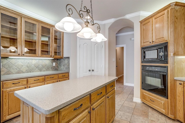 kitchen featuring a center island, black appliances, crown molding, hanging light fixtures, and decorative backsplash