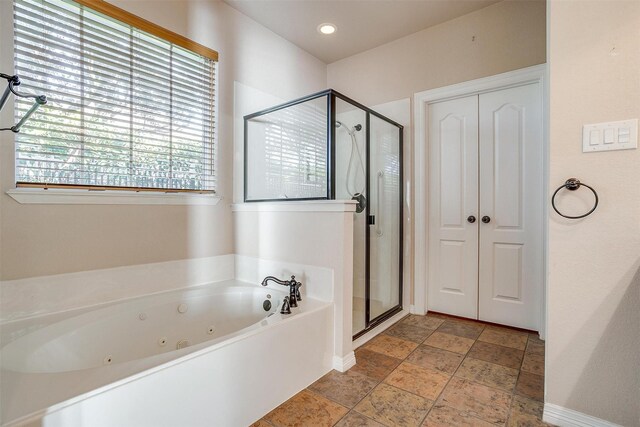 bathroom with shower with separate bathtub