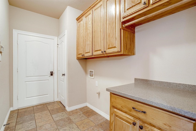 clothes washing area with washer hookup and cabinets