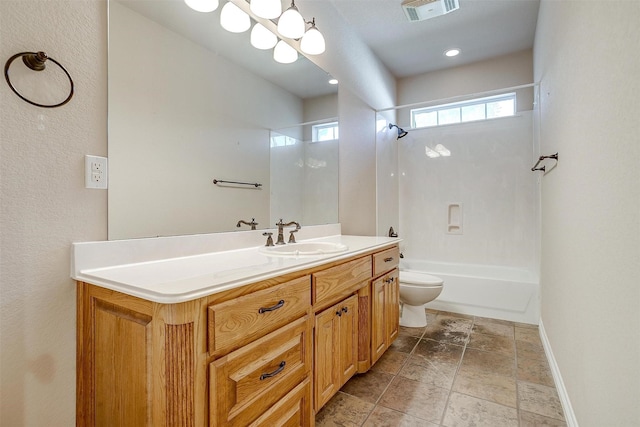 full bathroom featuring vanity, bathing tub / shower combination, and toilet