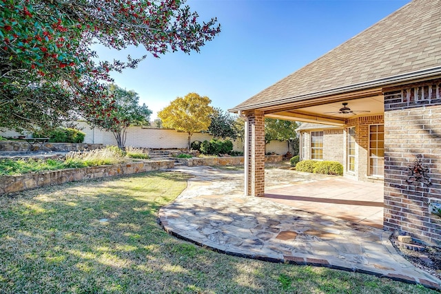 view of yard featuring a patio and ceiling fan