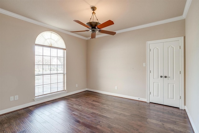 empty room featuring crown molding, ceiling fan, and dark hardwood / wood-style floors