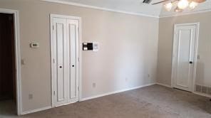 unfurnished room with carpet flooring, ceiling fan, and ornamental molding