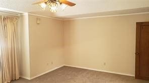 empty room with carpet floors and ceiling fan