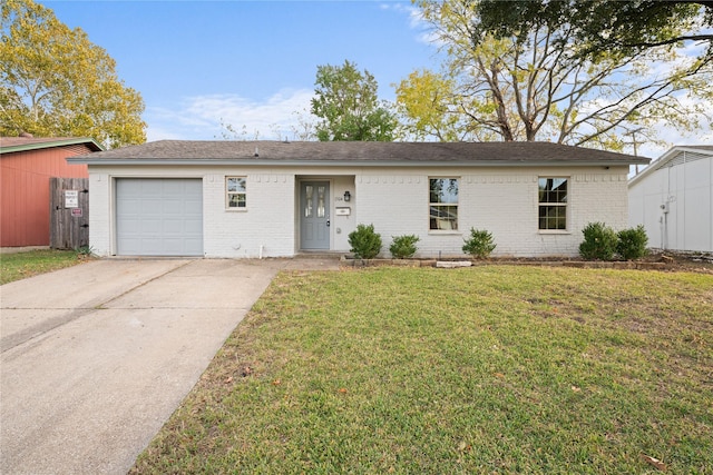 ranch-style home featuring a garage and a front lawn