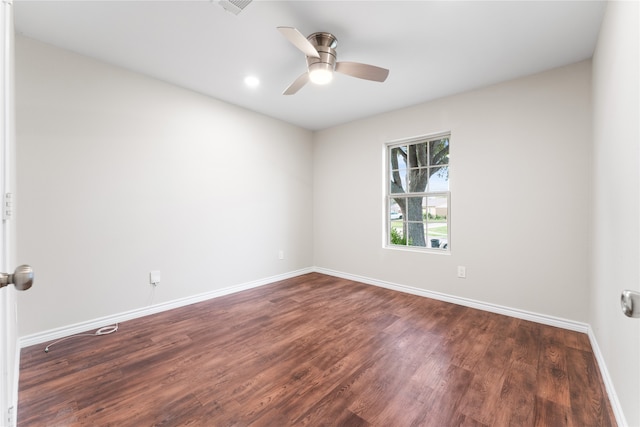 empty room featuring dark hardwood / wood-style flooring and ceiling fan