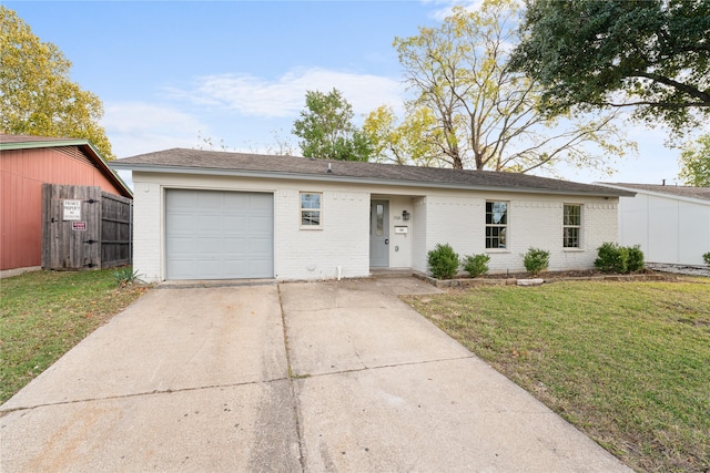 ranch-style house featuring a front lawn and a garage