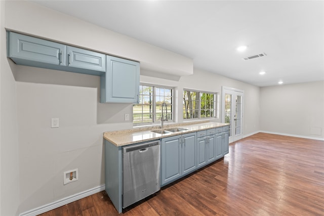 kitchen featuring light stone counters, sink, stainless steel dishwasher, and dark hardwood / wood-style floors