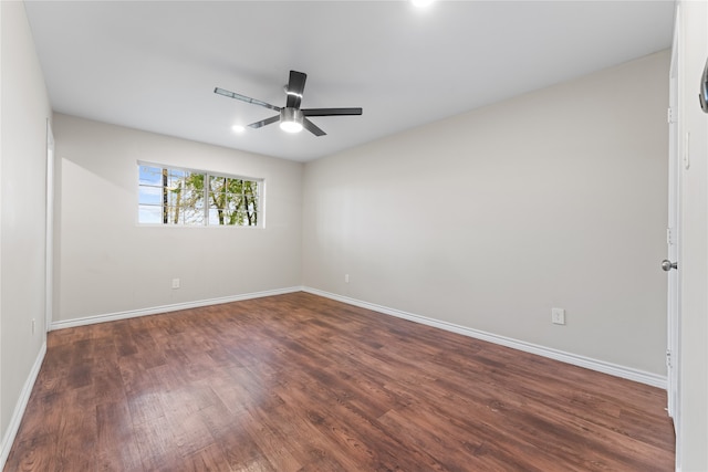 empty room featuring ceiling fan and dark hardwood / wood-style flooring