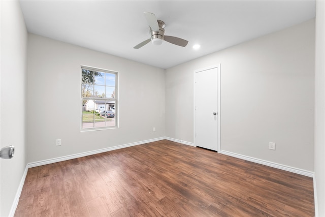 unfurnished room with dark hardwood / wood-style floors and ceiling fan