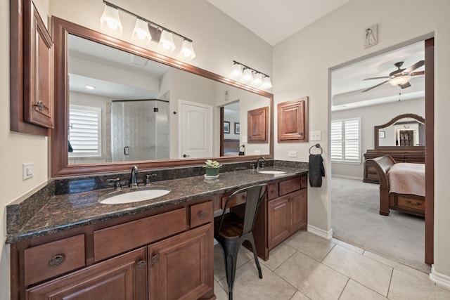 bathroom with tile patterned flooring, ceiling fan, a shower with door, and vanity