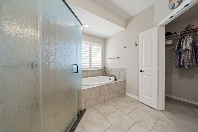 bathroom featuring tile patterned floors and separate shower and tub