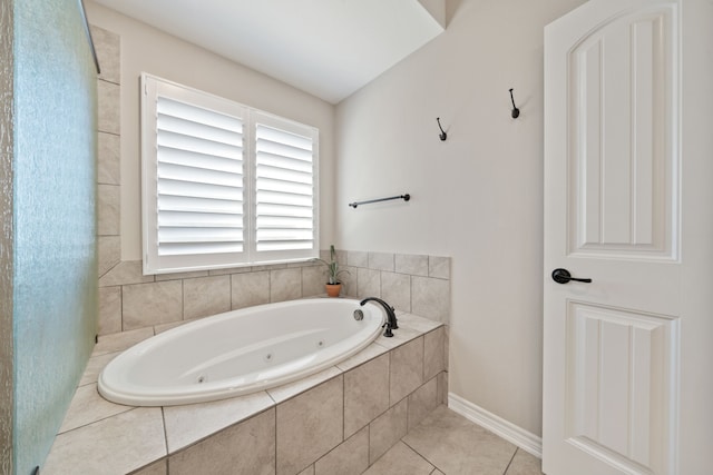 bathroom featuring tile patterned flooring and tiled tub