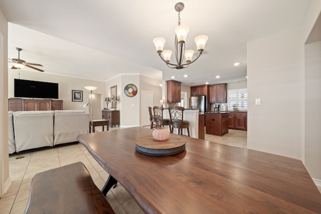 dining space with ceiling fan with notable chandelier and ornamental molding