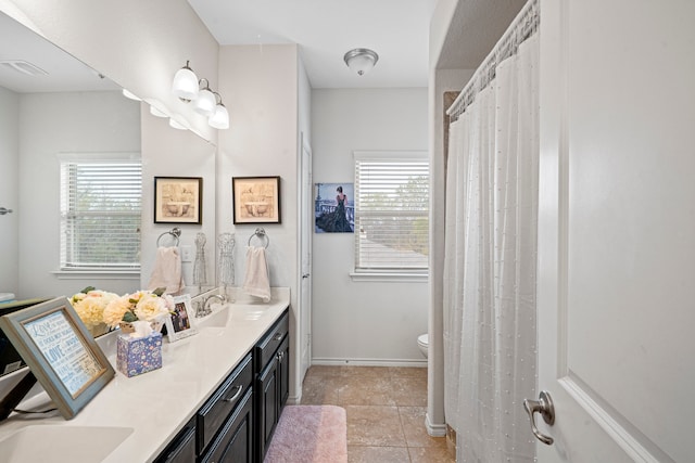 bathroom with tile patterned floors, vanity, and toilet