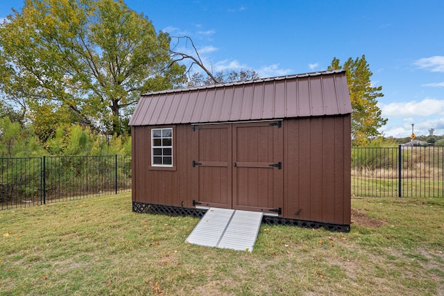 view of outdoor structure featuring a lawn