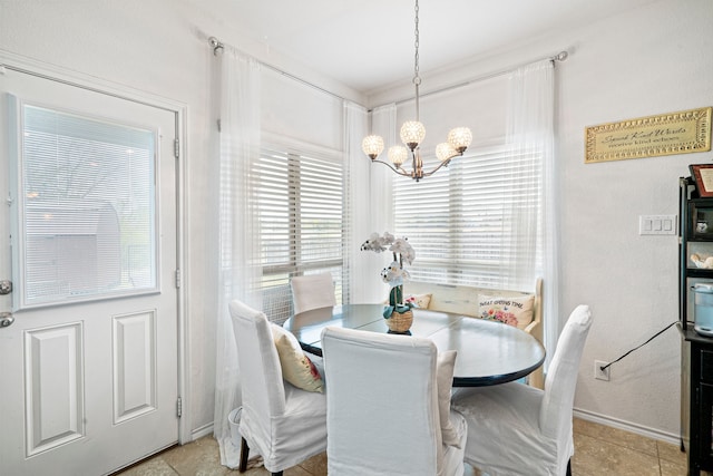 dining room featuring a notable chandelier and light tile patterned flooring