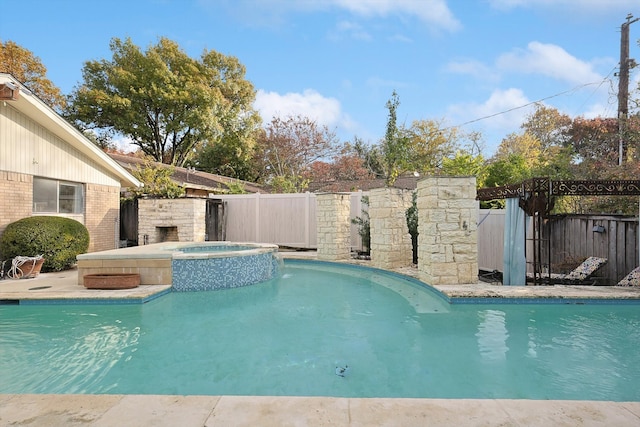 view of pool with an in ground hot tub