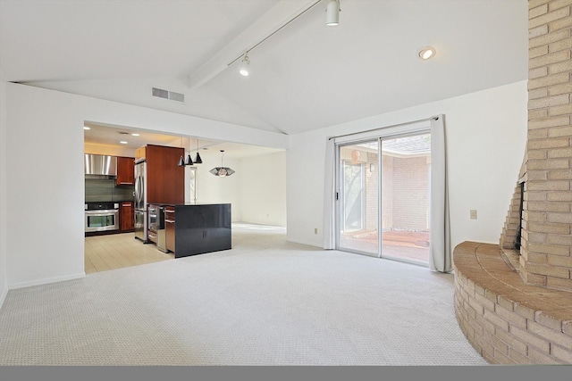 living room featuring track lighting, lofted ceiling with beams, and light carpet