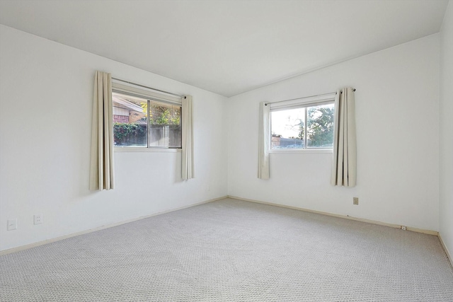 carpeted spare room with plenty of natural light