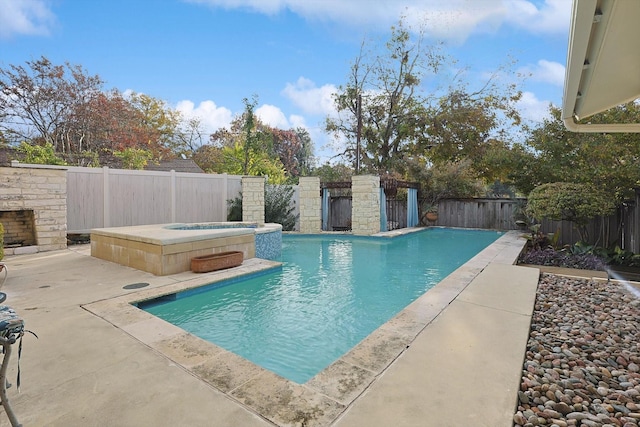 view of swimming pool with an in ground hot tub and a patio area