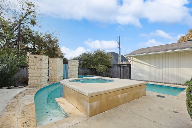 view of pool with an in ground hot tub