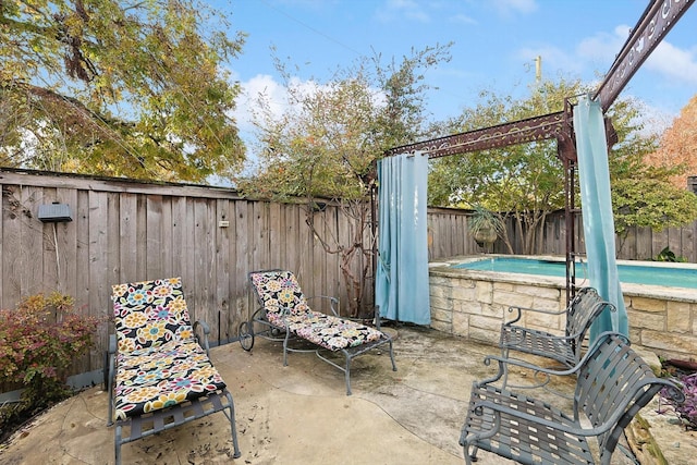 view of patio with a fenced in pool