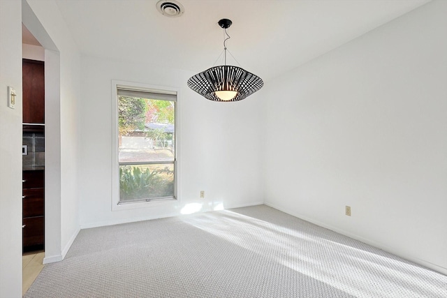 spare room with light colored carpet