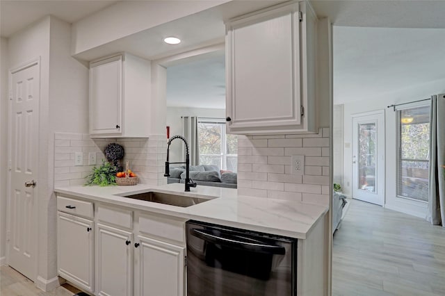 kitchen with light hardwood / wood-style floors, dishwasher, sink, and white cabinets