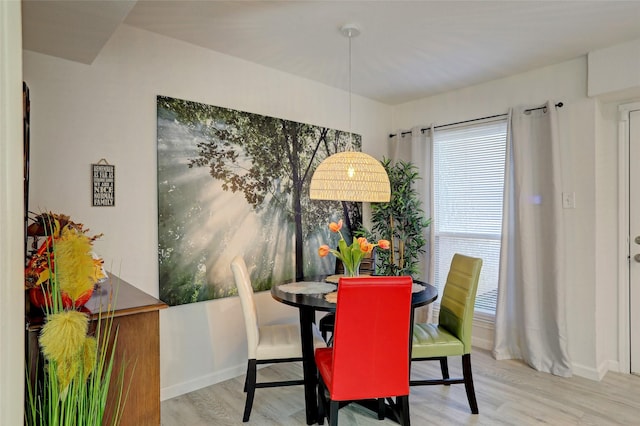 dining space with light wood-type flooring