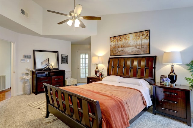 bedroom with ceiling fan, light colored carpet, and high vaulted ceiling