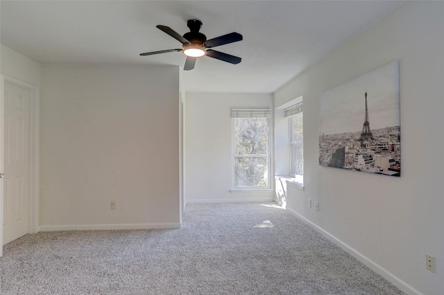 spare room featuring carpet flooring and ceiling fan