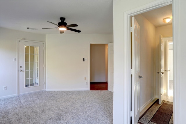 empty room featuring carpet floors and ceiling fan