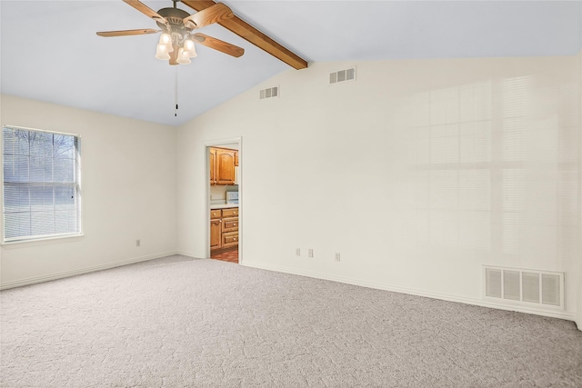 carpeted empty room featuring lofted ceiling with beams and ceiling fan