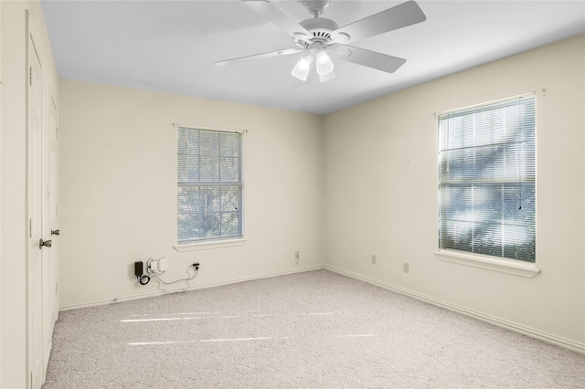 unfurnished room with ceiling fan and light colored carpet