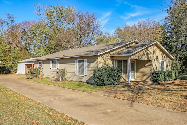 single story home featuring a front yard and a garage