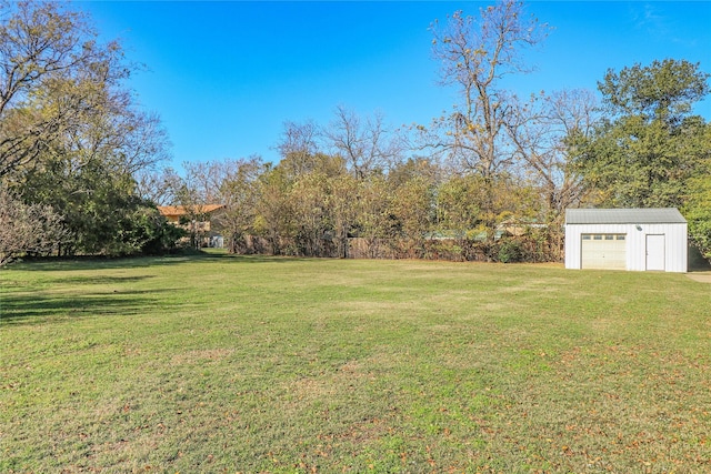 view of yard featuring a garage and an outdoor structure