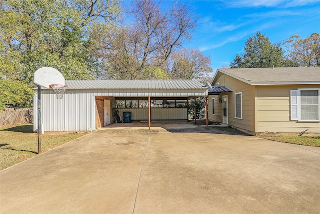 view of parking featuring a yard and a carport