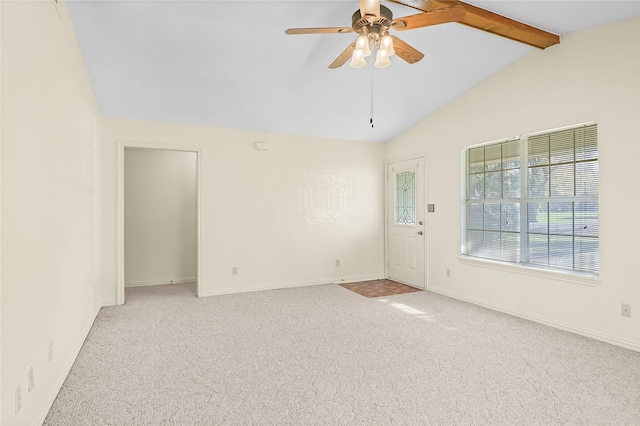 spare room featuring ceiling fan, light colored carpet, and lofted ceiling with beams