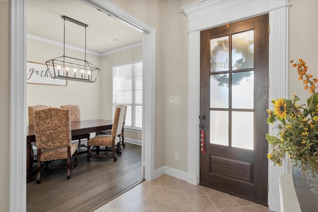 tiled foyer entrance featuring ornamental molding