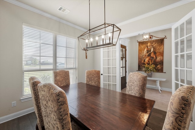 dining room featuring crown molding and hardwood / wood-style flooring