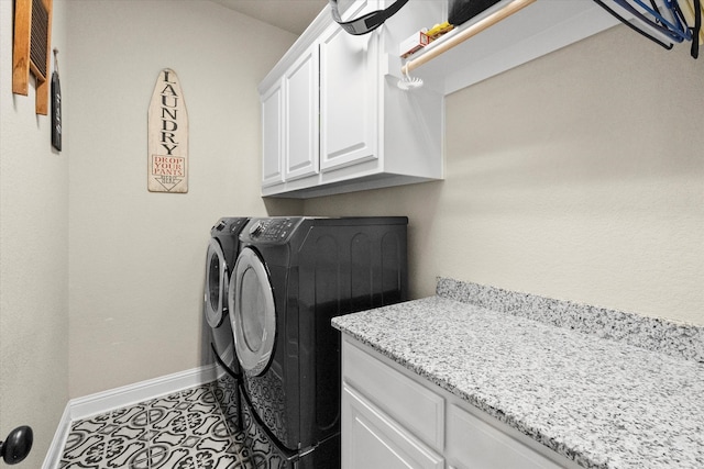 clothes washing area featuring cabinets, separate washer and dryer, and light tile patterned floors